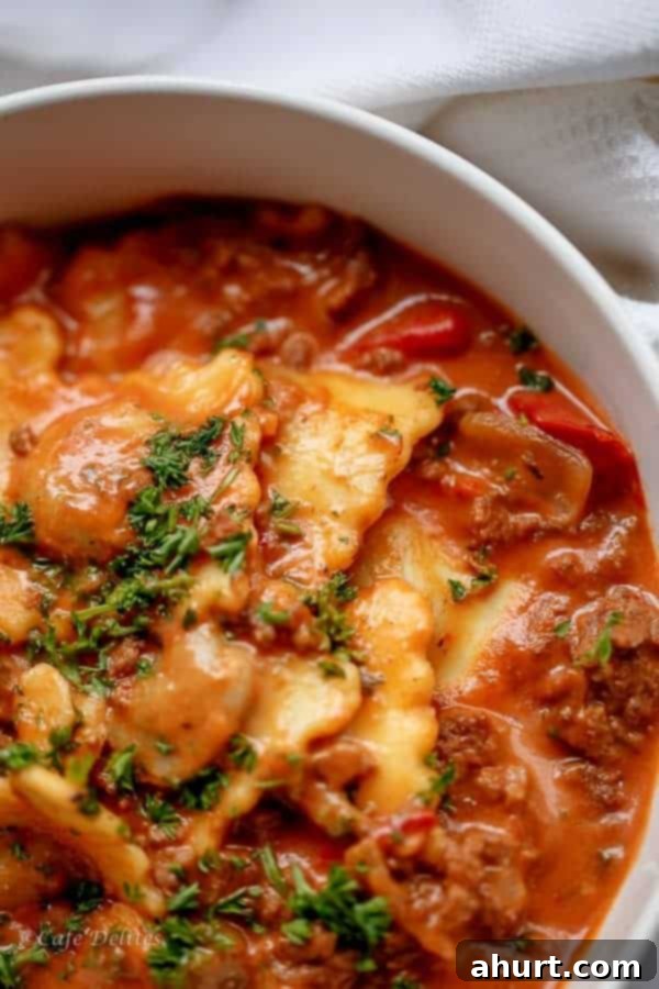 A close-up, tempting shot of the creamy tomato beef ravioli, highlighting the textured sauce, soft pasta, and rich colors, inviting a taste.