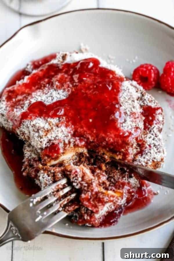 Lamington French Toast with Sweet Raspberry Drizzle 3 Stack of Lamington French Toasts topped with fresh raspberries and a generous drizzle of raspberry sauce