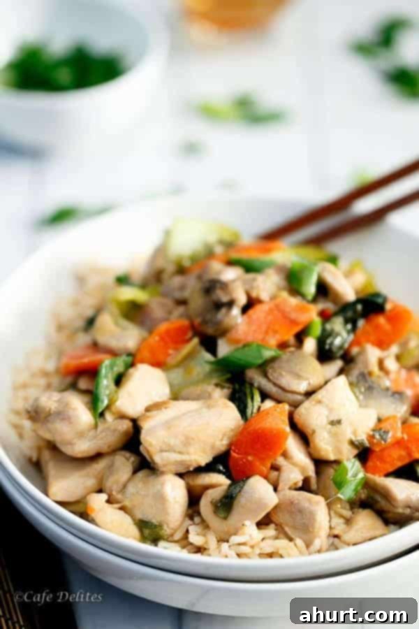 Close-up of Honey Mustard Chicken Stir Fry served in a bowl with chopsticks, ready to eat
