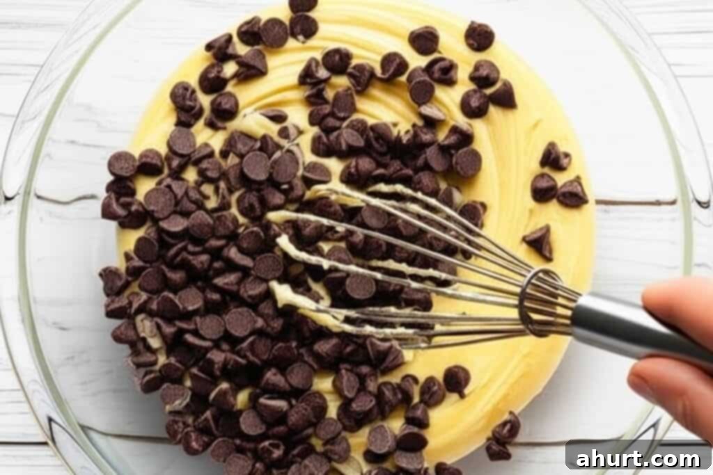 Decadent Nutella Cookie Pie 5 Step 3: Adding dry ingredients and first layer of chocolate chips to the Nutella Cookie Pie dough.