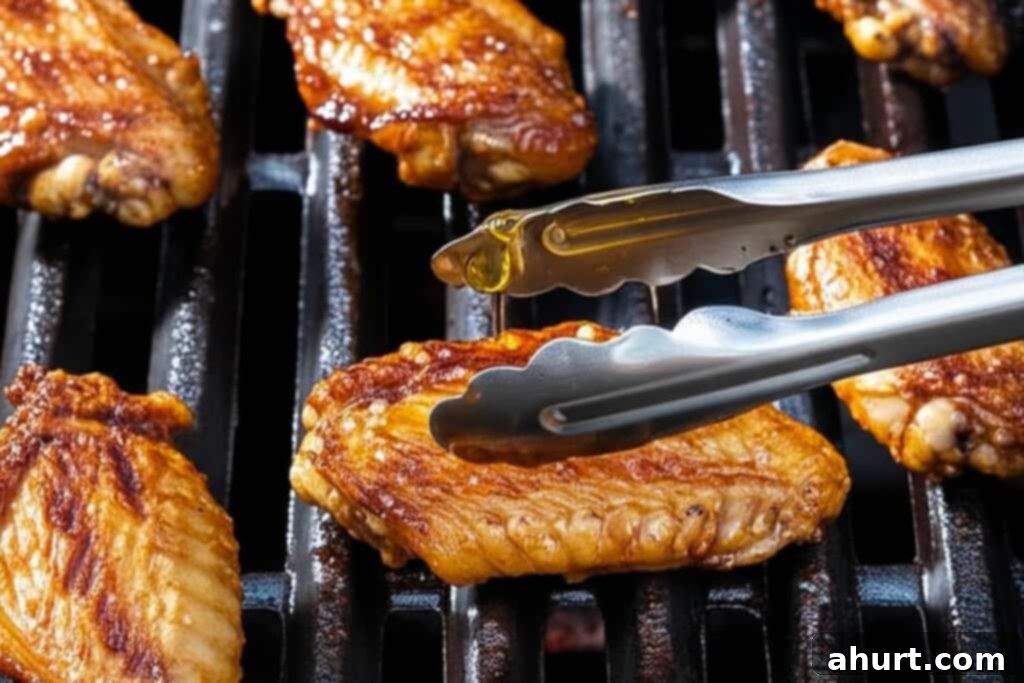 Honey Sesame Glazed Chicken 6 Chicken wings grilling in the oven, becoming golden and sticky.