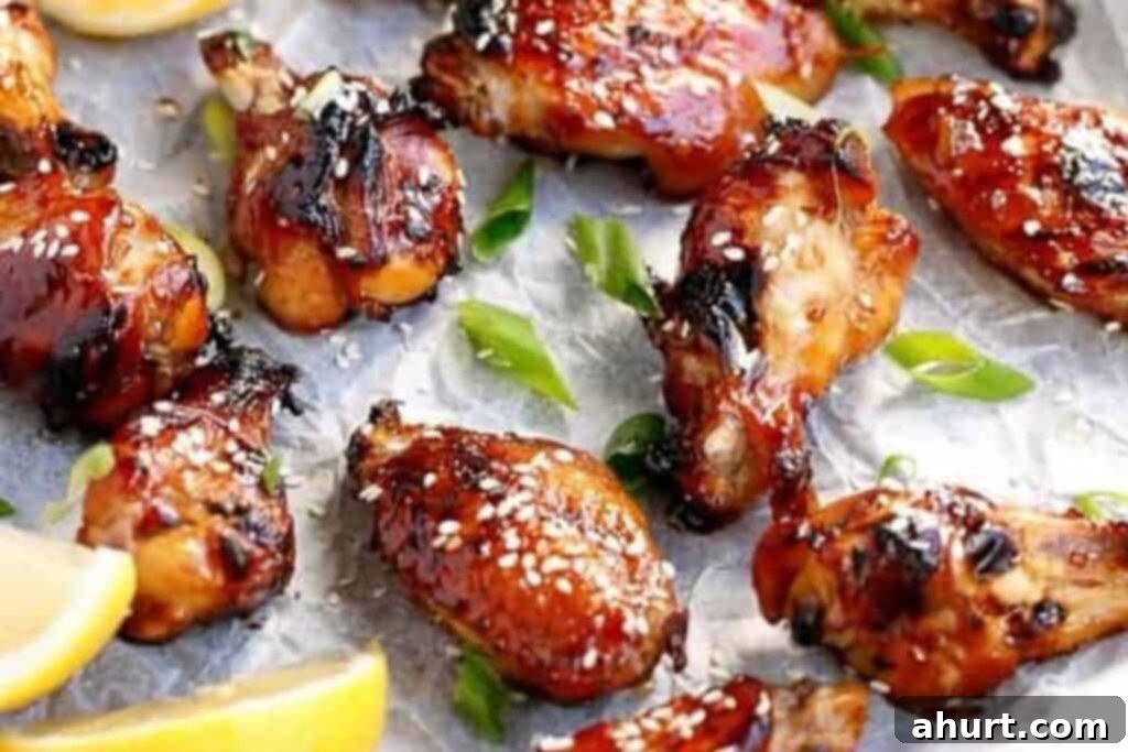 Honey Sesame Glazed Chicken 7 Finished honey sesame chicken wings garnished with sesame seeds and lemon.