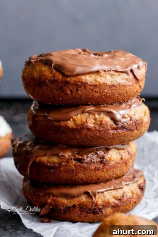 Warm Banana Bread Doughnuts, Bursting with Nutella 2 A stack of Nutella topped donuts on each other