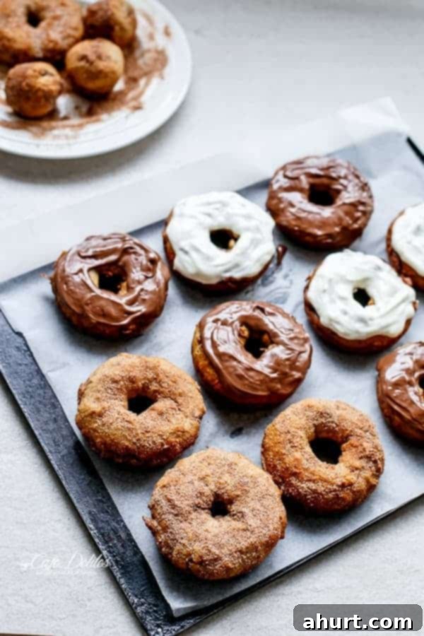 Warm Banana Bread Doughnuts, Bursting with Nutella 5 A tray with assorted banana bread donuts with different toppings, Nutella, cream cheese donuts and cinnamon sugar