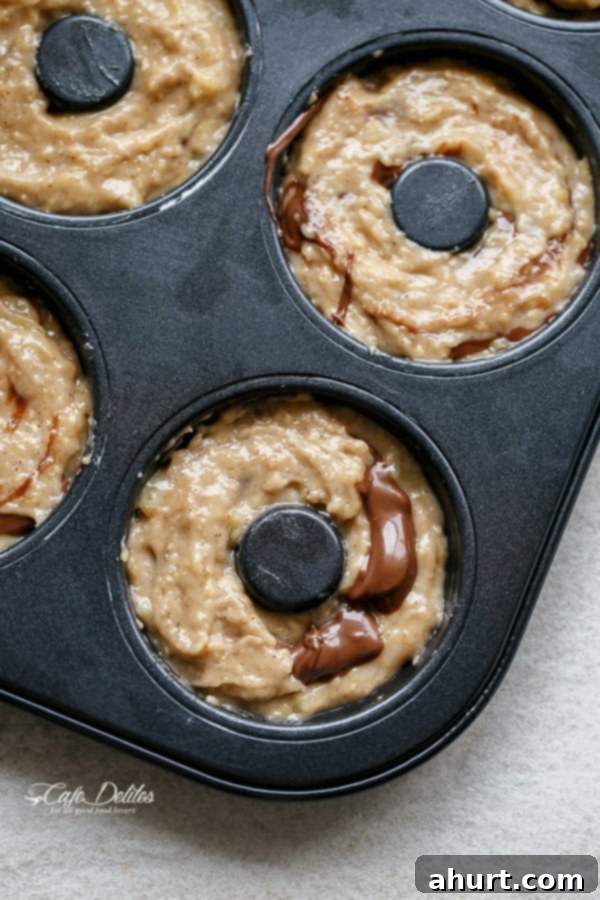Warm Banana Bread Doughnuts, Bursting with Nutella 6 raw nutella stuffed banana bread donuts in a donut mold backing tray
