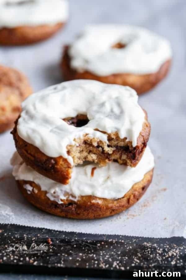 Warm Banana Bread Doughnuts, Bursting with Nutella 9 cream cheese topped of donuts with a bite taken out