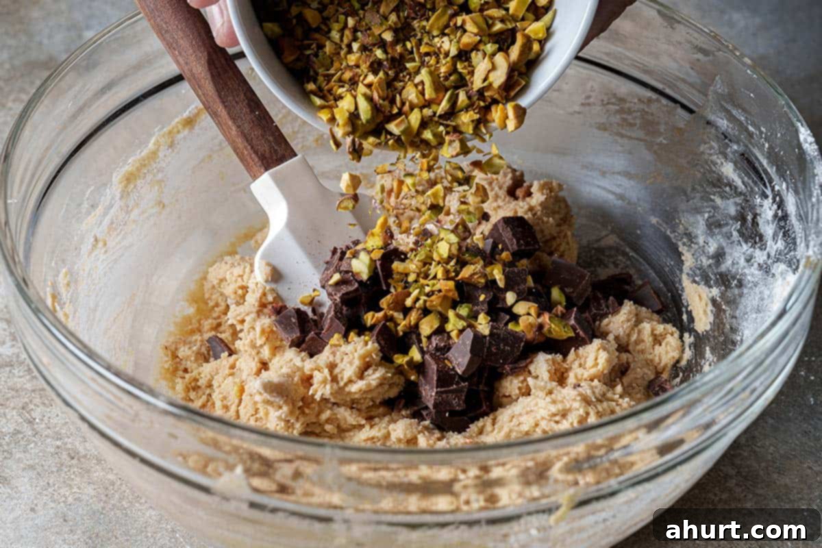 Pistachio Chocolate Chip Skillet Cookie 7 Step 4: Fold in half of the chocolate chips and half of the chopped pistachios into the cookie dough.