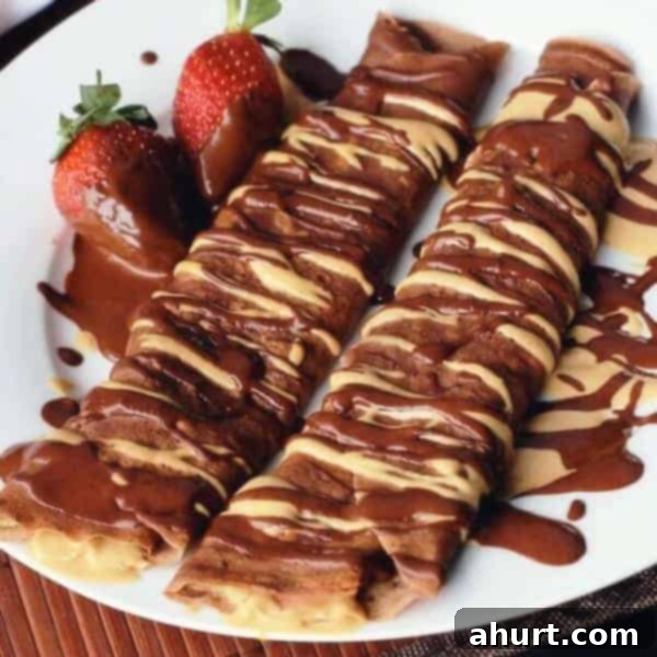 Chocolate Peanut Butter Cup Crepes with fresh strawberries on a plate