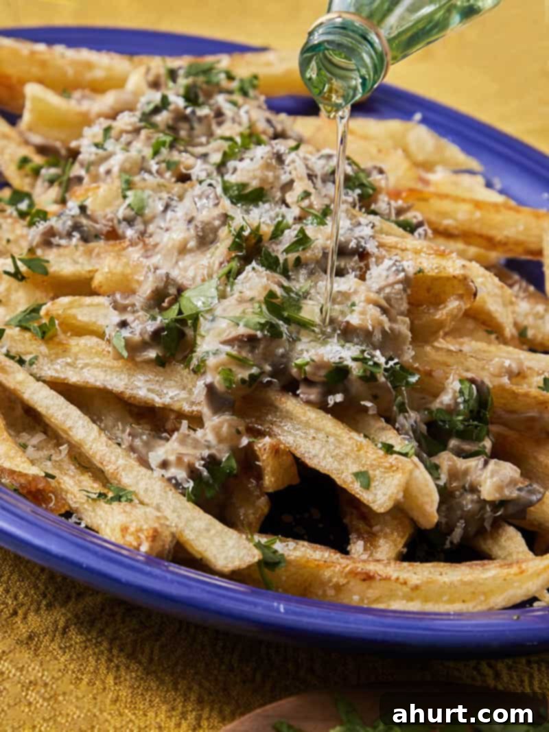 Handcrafted Truffle Fries 12 A close-up of the delicious truffle fries in a blue bowl, showcasing the crispy texture and rich topping.
