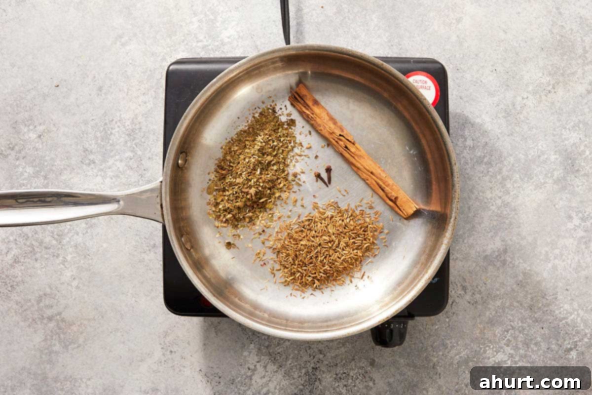 Birria Tacos Simplified 5 Dry spices toasting in a pan.