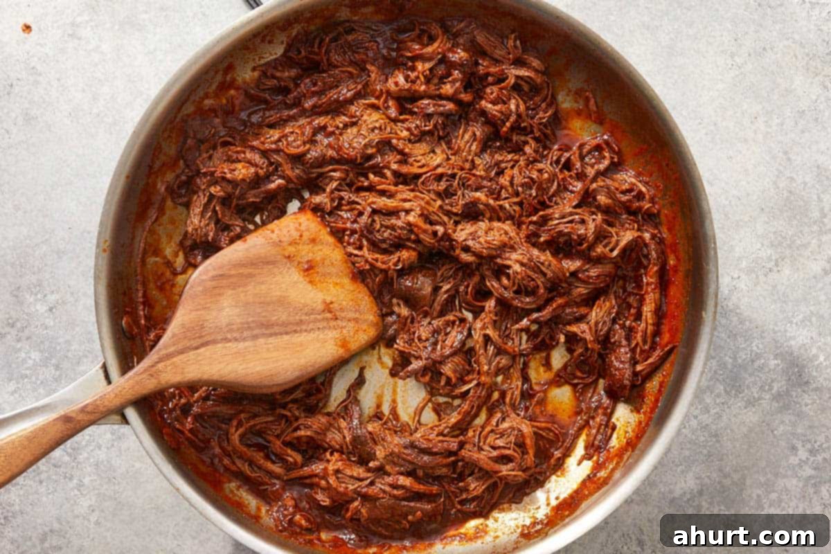 Birria Tacos Simplified 10 Shredded birria meat in skillet