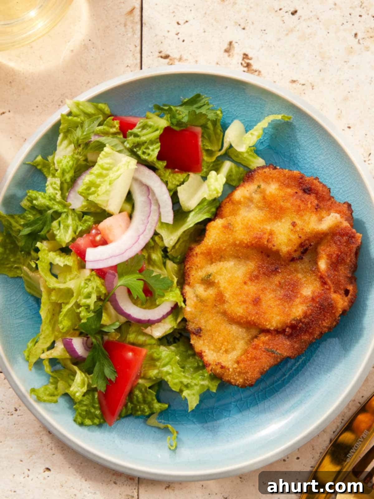 The Ultimate Beef Milanesa Experience 2 Crispy golden beef milanesa served with tomato salad.