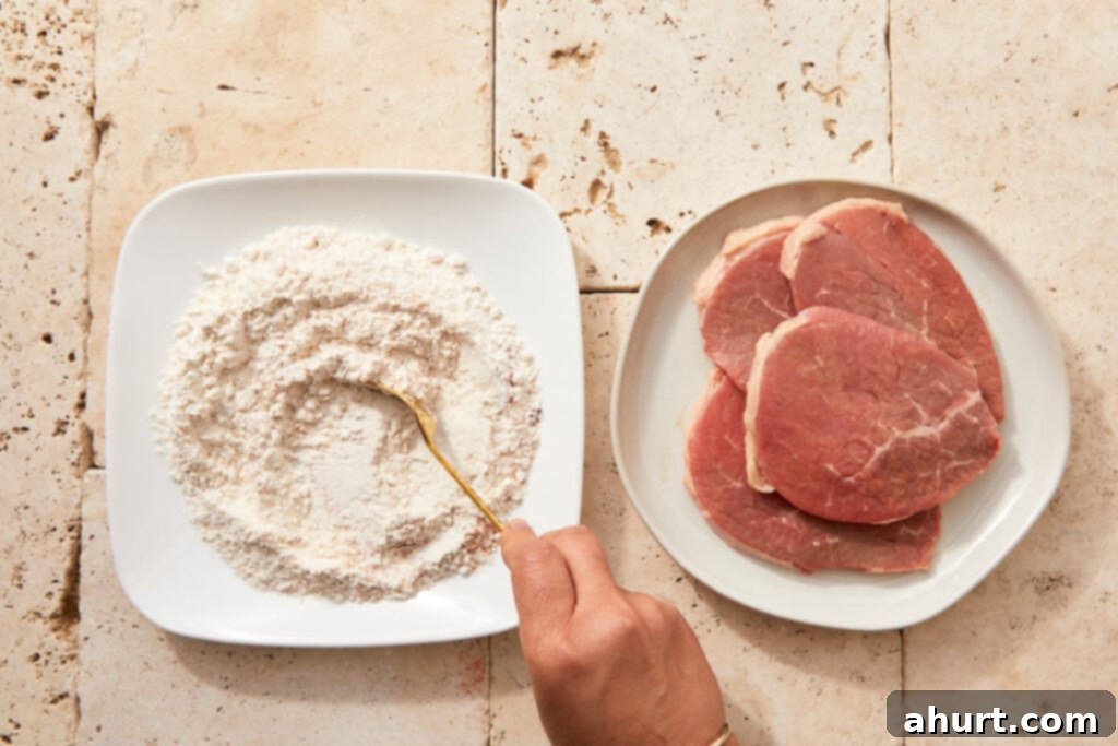 The Ultimate Beef Milanesa Experience 4 Flour mixed with paprika, salt, pepper, and garlic powder in a shallow bowl