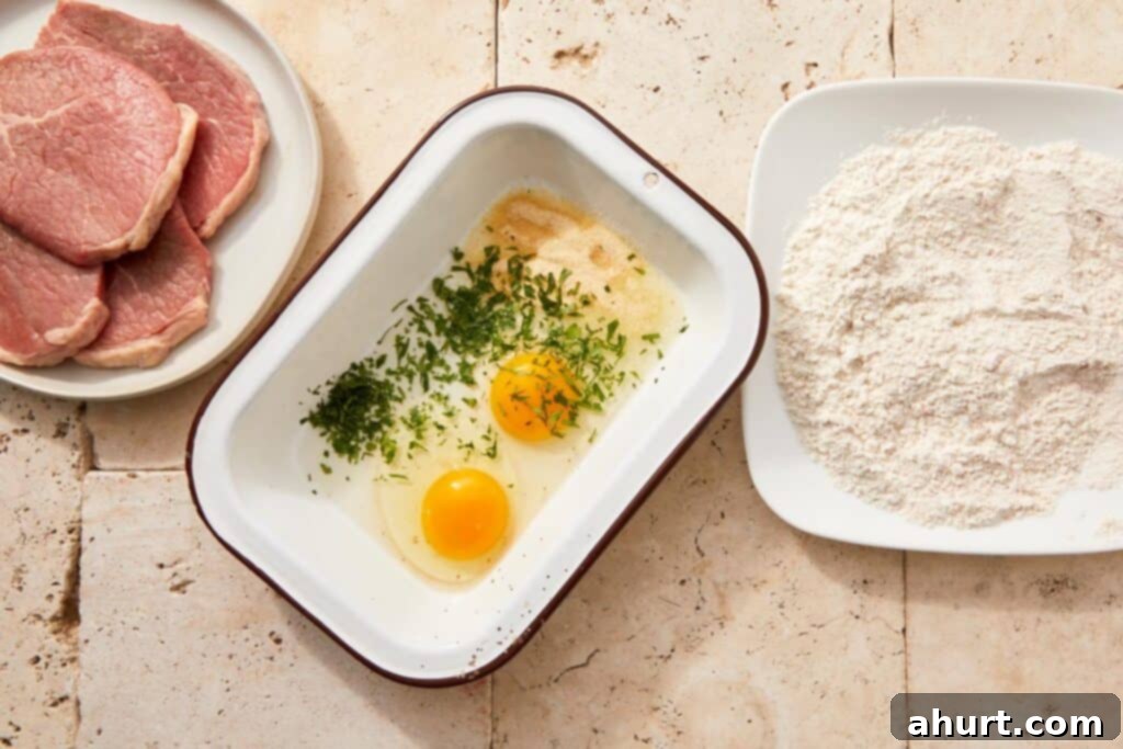 The Ultimate Beef Milanesa Experience 5 Eggs whisked with parsley, salt, and onion powder in a glass bowl