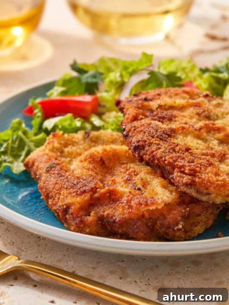 The Ultimate Beef Milanesa Experience 10 Close-up of crispy beef milanesa served with salad.