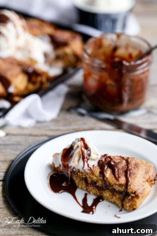 Nutella Stuffed Churro Deep Dish Skillet Cookie slice on a plate, showing texture