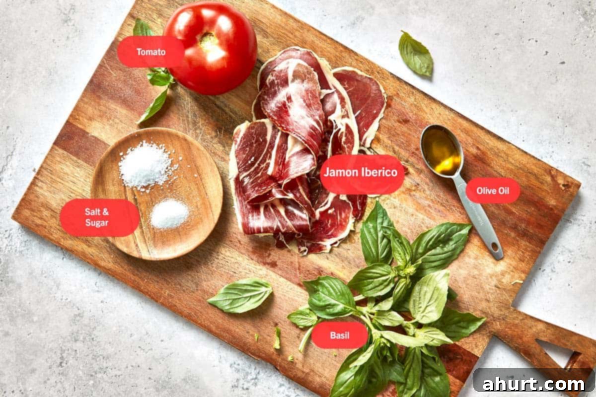 Spanish Tomato Pan Coca 3 Ingredients for Spanish tomato bread laid out on a wooden board.