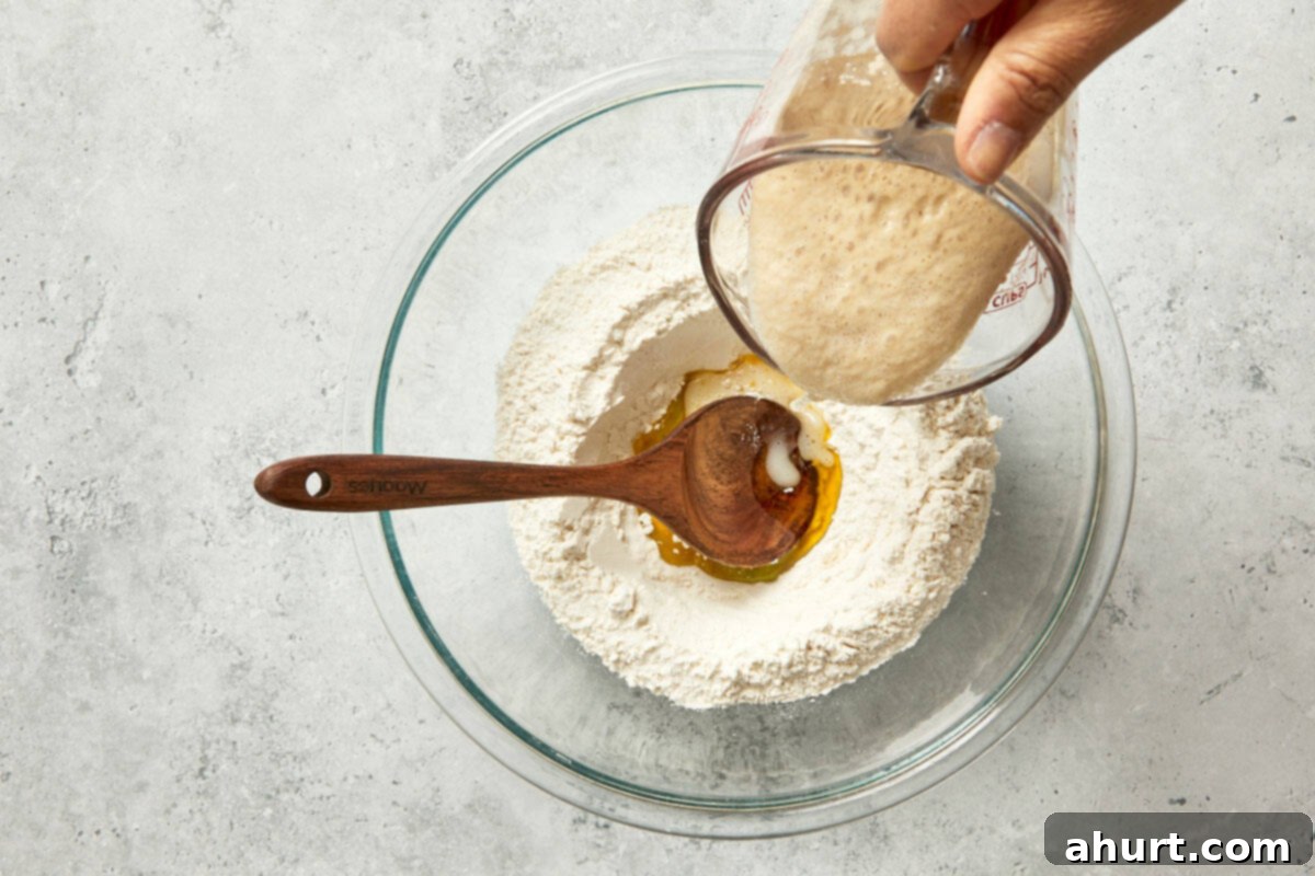 Spanish Tomato Pan Coca 5 Pouring yeast into a bowl of flour and olive oil to start the Pan Coca dough.