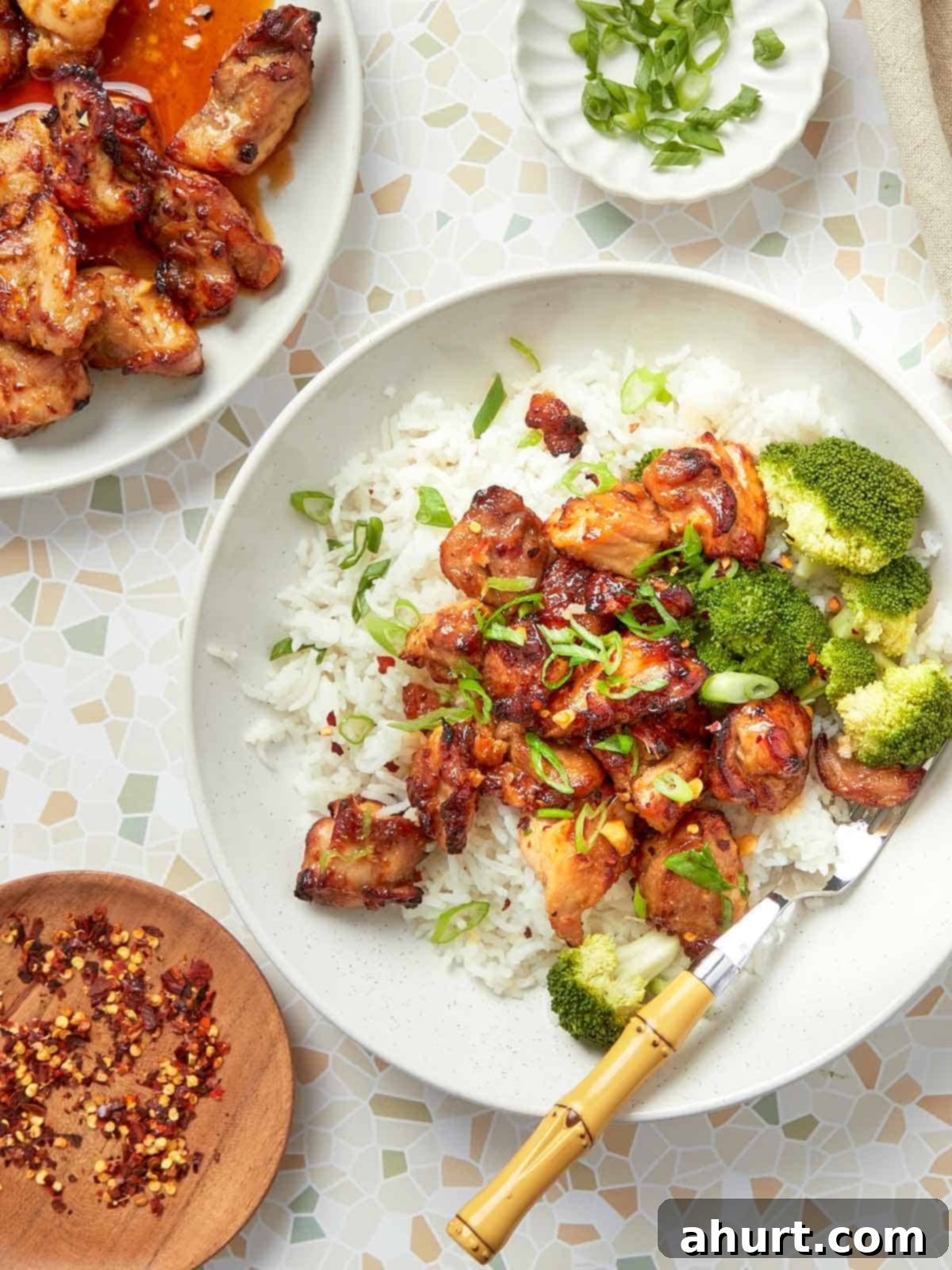 Crispy Air Fryer Teriyaki Chicken Thighs 2 Crispy air fryer teriyaki chicken served over fluffy white rice with steamed broccoli and sliced green onions.