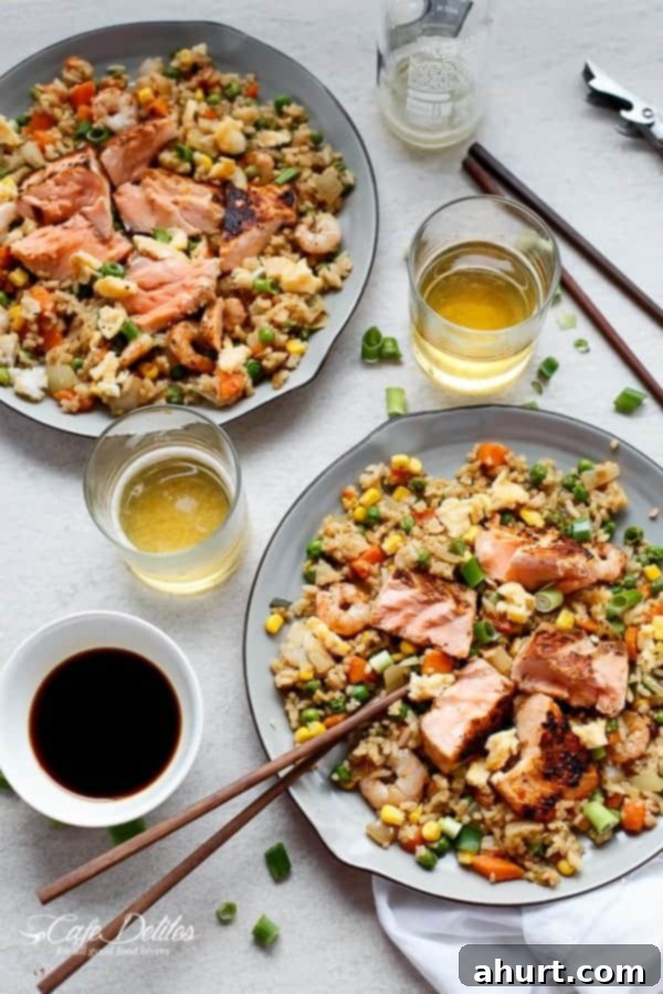 Seared Salmon and Prawn Fried Rice with chop sticks on a plate