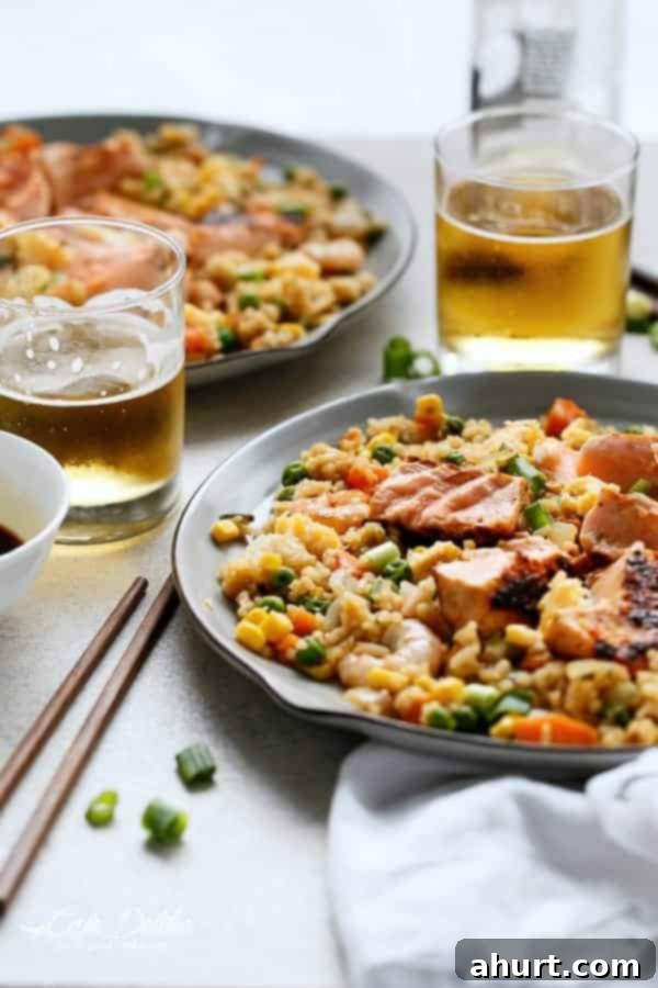 Seared Salmon And Prawn Fried Rice with some drinks in the background