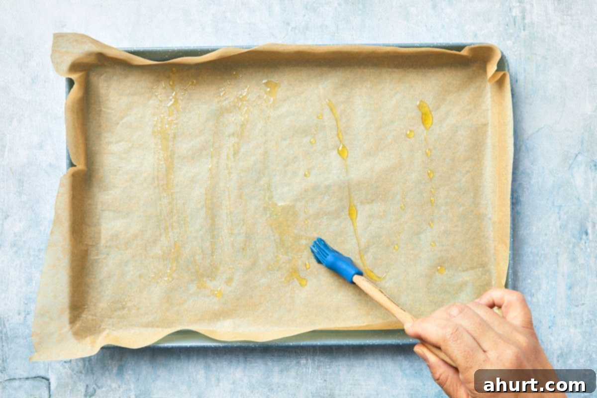 Effortless Homemade Focaccia 8 Rectangular baking pan lined with parchment and generously brushed with olive oil.
