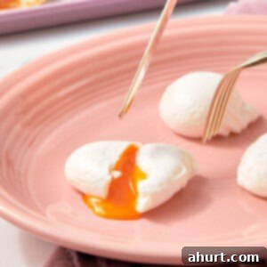 Mastering Perfect Poached Eggs 7 Poached Eggs on a pink plate with a fork.