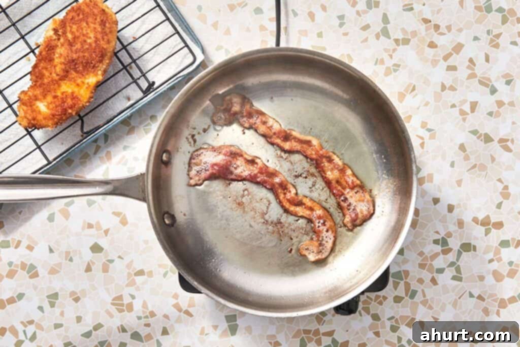 Signature Crispy Caesar Wrap 11 Slicing crispy chicken into strips and breaking bacon into pieces.
