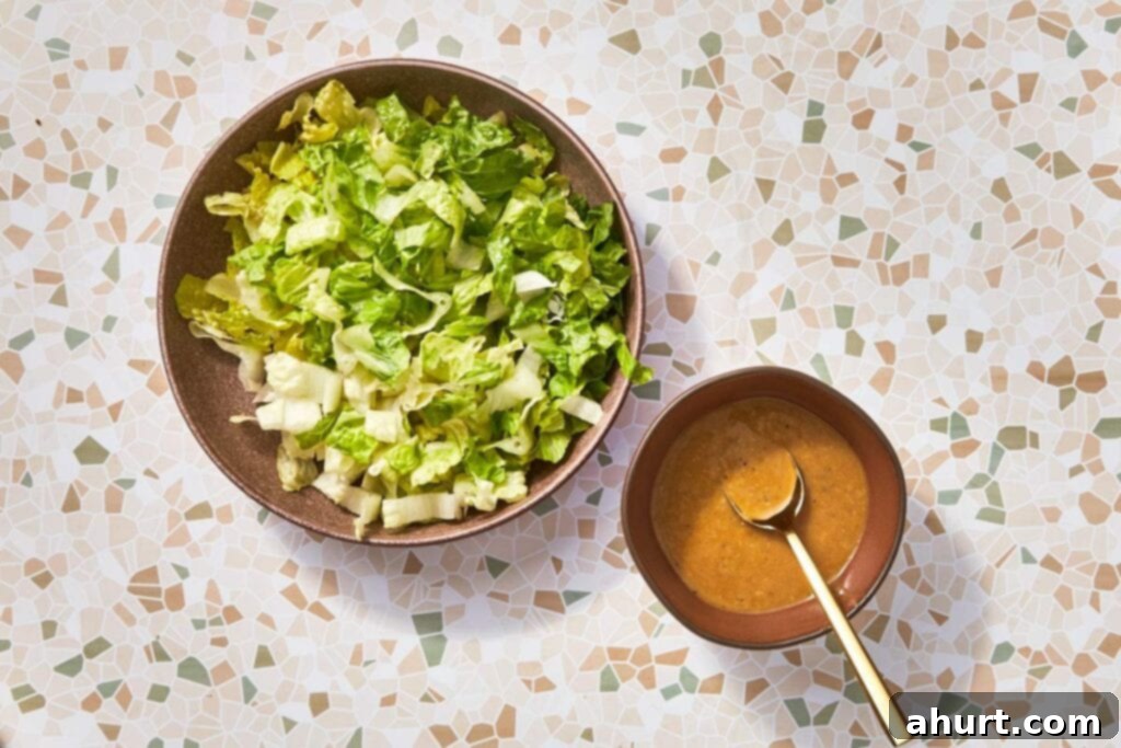 Signature Crispy Caesar Wrap 12 Tossing chopped romaine lettuce with Caesar dressing.
