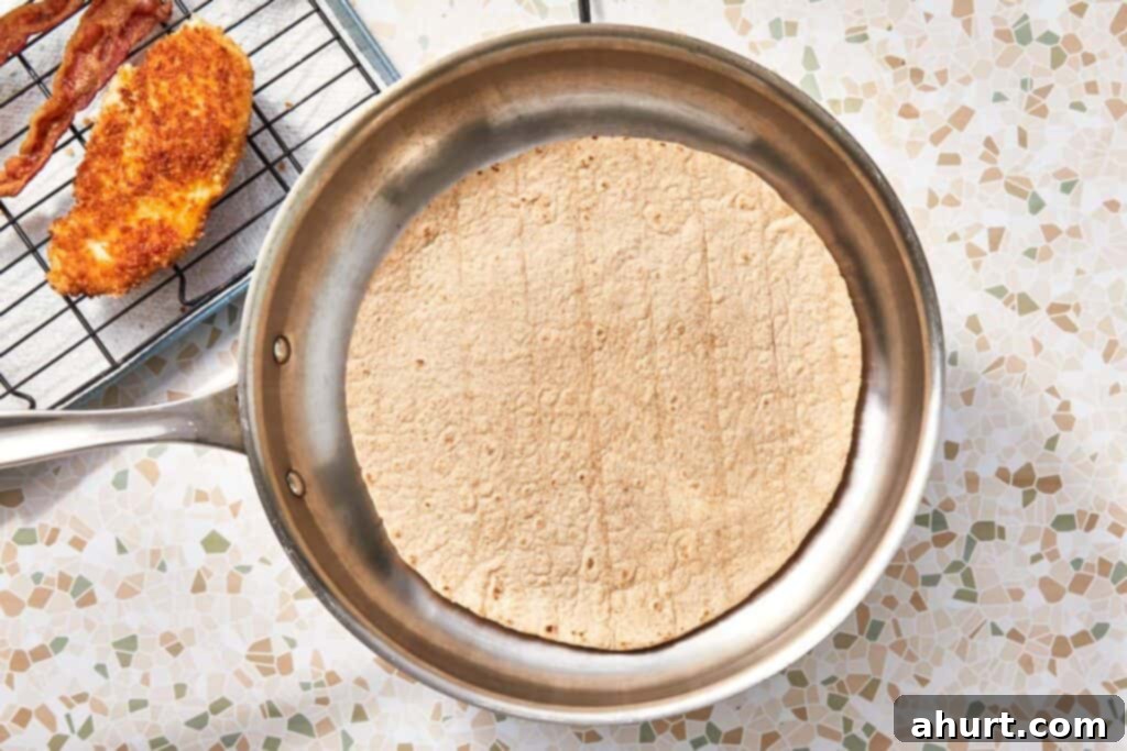 Signature Crispy Caesar Wrap 13 Warming a large tortilla in a dry pan.