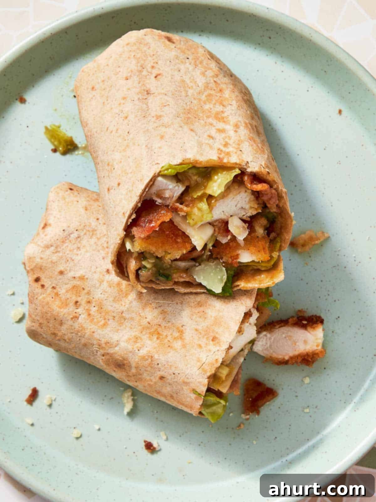 Signature Crispy Caesar Wrap 18 A close-up of a Crispy Chicken Caesar Wrap, showcasing the crispy chicken and creamy dressing.