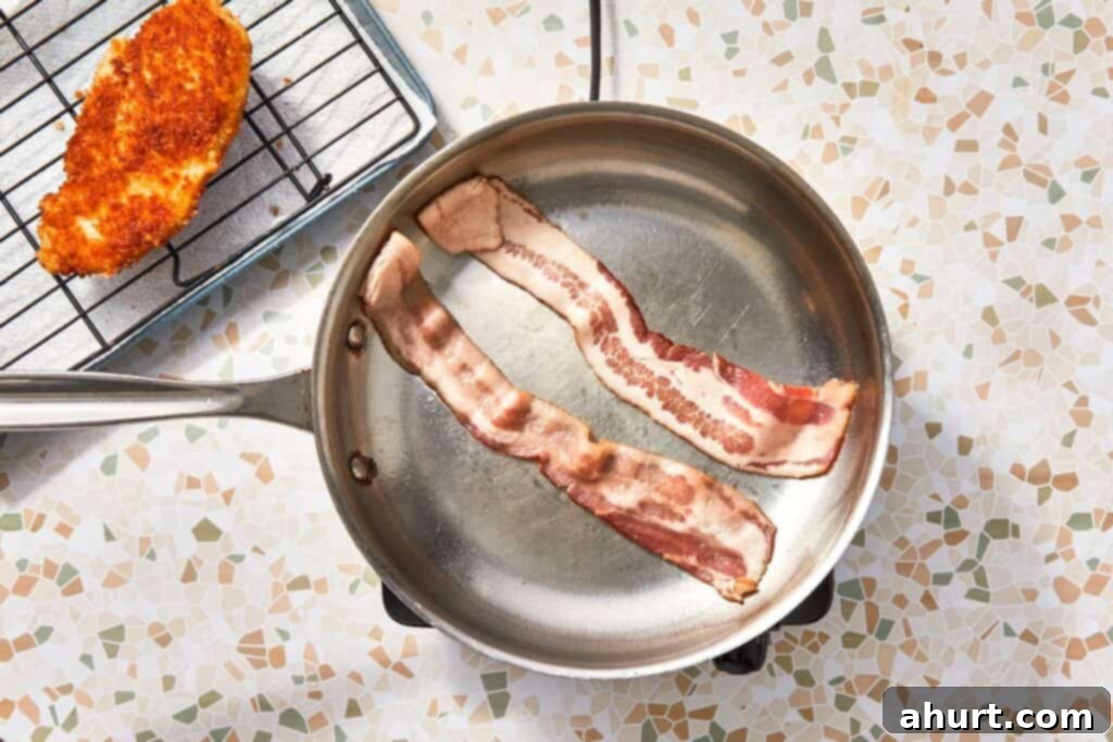 Signature Crispy Caesar Wrap 10 Bacon cooking in a pan until crispy.