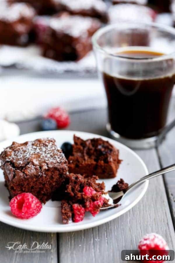 Berry Burst Nutella Swirl Brownies 2 Mixed Berry Nutella Brownies piece with some fresh berries on a plate