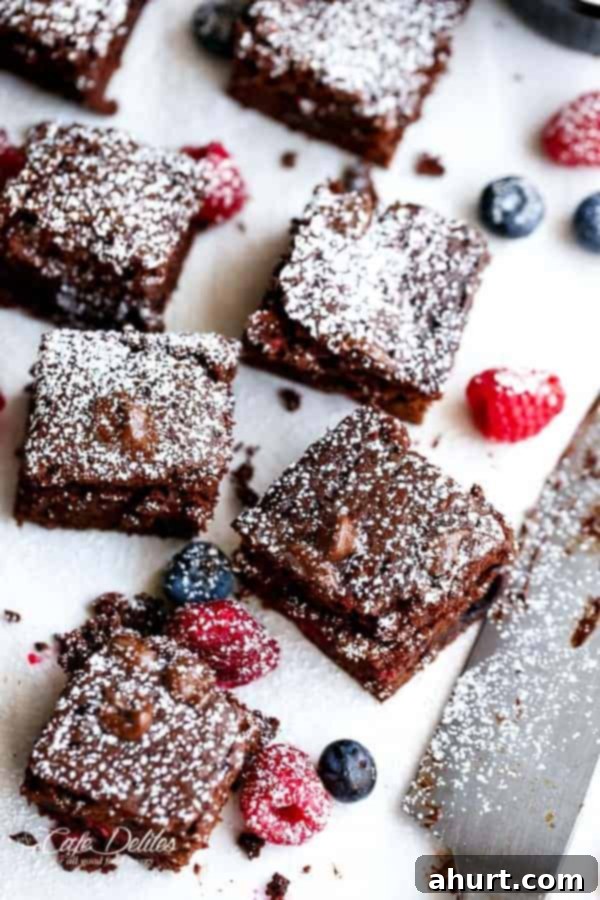 Berry Burst Nutella Swirl Brownies 12 Mixed Berry Nutella Brownies pieces fully covered with powdered sugar