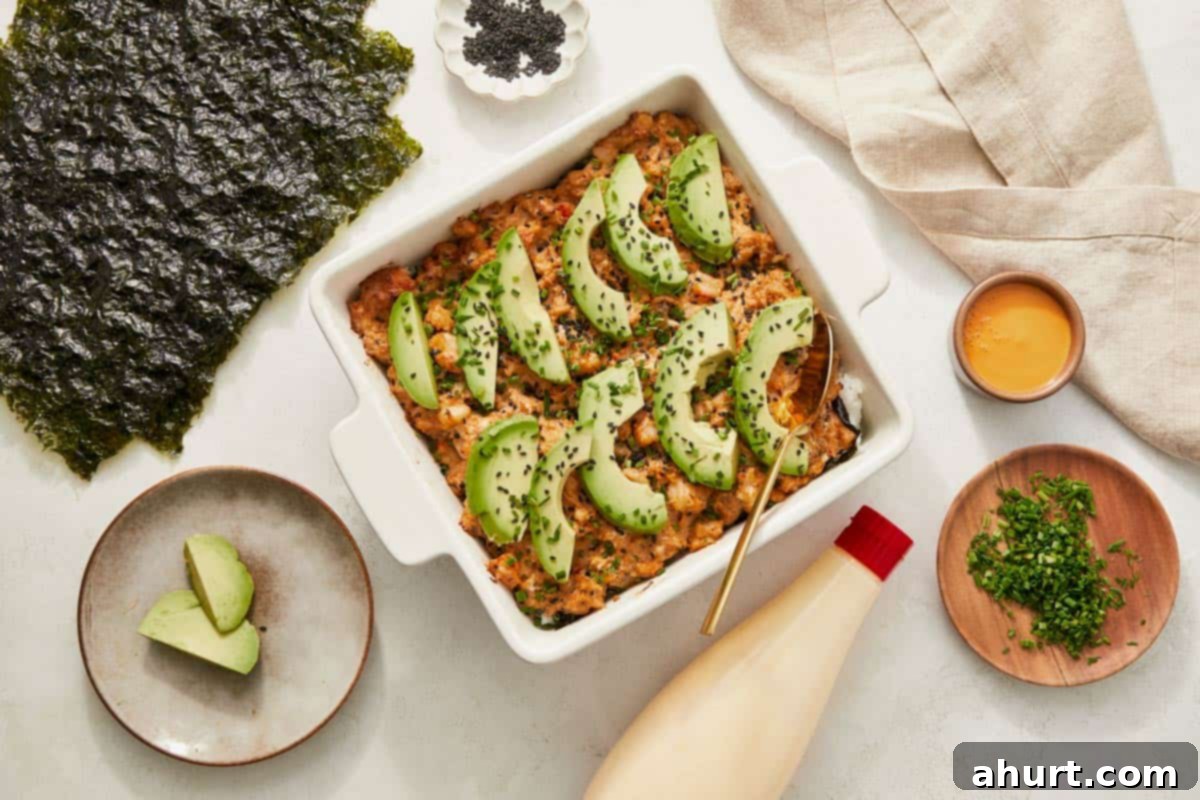 Easy At-Home Sushi Bake 11 A cooked sushi bake casserole featuring avocado, green beans, and various other ingredients, served in a baking dish.