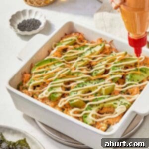 Easy At-Home Sushi Bake 13 A serving of Sushi Bake garnished with creamy avocado, highlighting the dish's vibrant and inviting appearance.