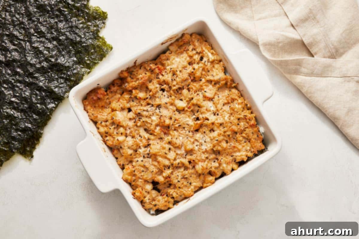 Easy At-Home Sushi Bake 9 A baked sushi casserole showcasing rice and seaweed in a ceramic dish