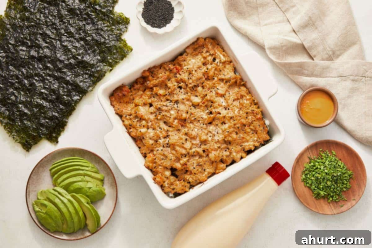 Easy At-Home Sushi Bake 10 A casserole dish filled with cooked sushi bake, showcasing layers of rice, avocado, and assorted toppings.