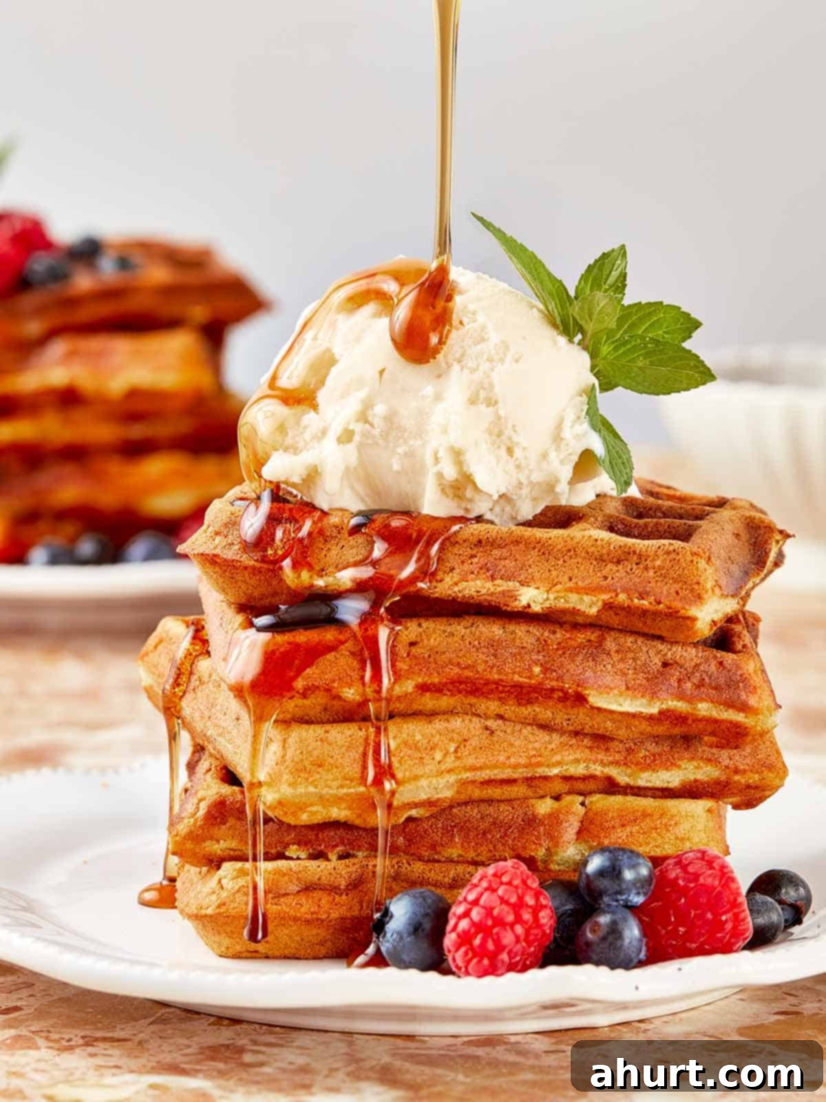 The Ultimate Paffles Waffle Pancake Perfection 2 A stack of golden Wancakes with syrup cascading over them, showcasing a delightful breakfast option.