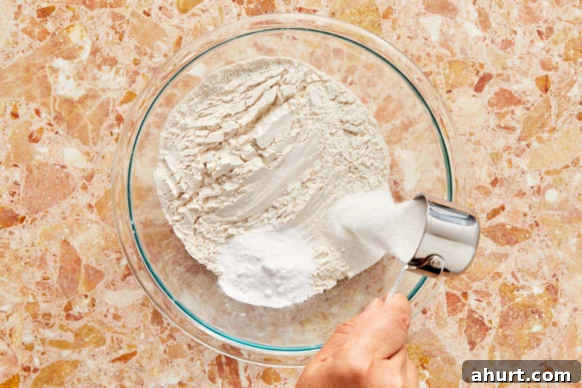The Ultimate Paffles Waffle Pancake Perfection 4 Mixing flour in a bowl, preparing dry ingredients for a recipe.