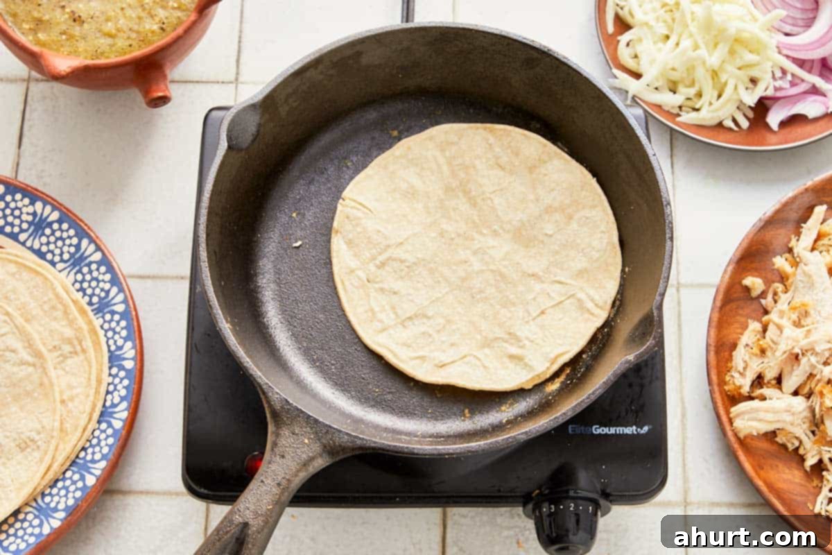 Green Enchiladas 5 A skillet filled with soft tortillas and assorted ingredients.