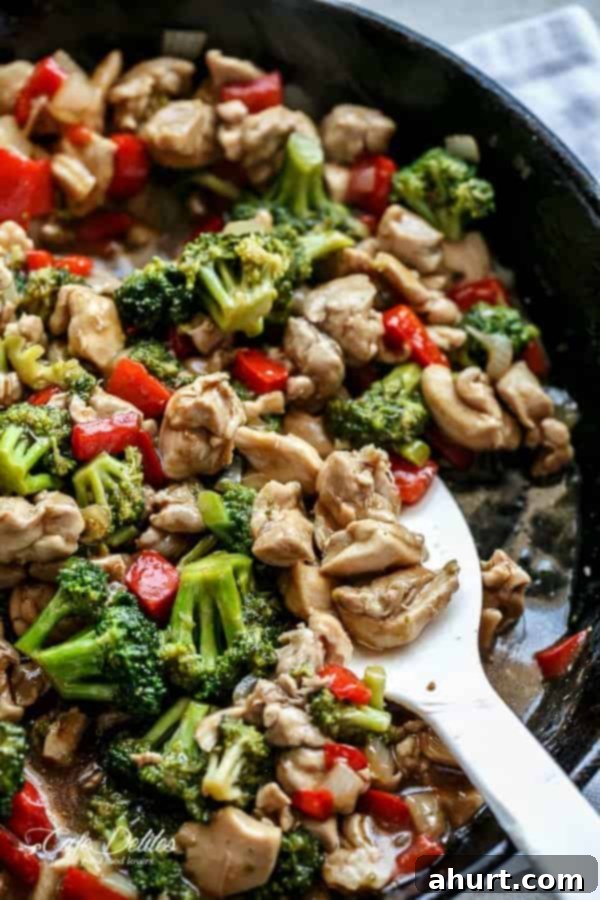 Sticky Hoisin Chicken and Broccoli Stir-Fry 5 Hoisin Chicken and Broccoli in a pan with spoon carrying some chicken pieces