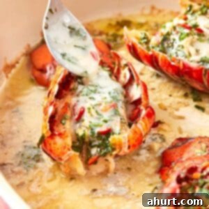 Sizzling Lobster Tails with Herbaceous Chimichurri 11 Close-up of a lobster tail being drizzled with creamy chimichurri butter, highlighting the vibrant herbs and rich sauce pooling in the baking dish.