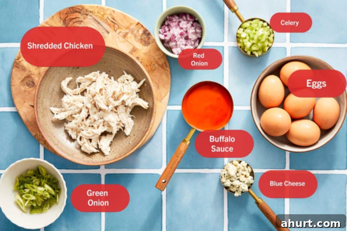 Spicy Buffalo Chicken Deviled Eggs 3 Ingredients for buffalo chicken deviled eggs on blue tile.