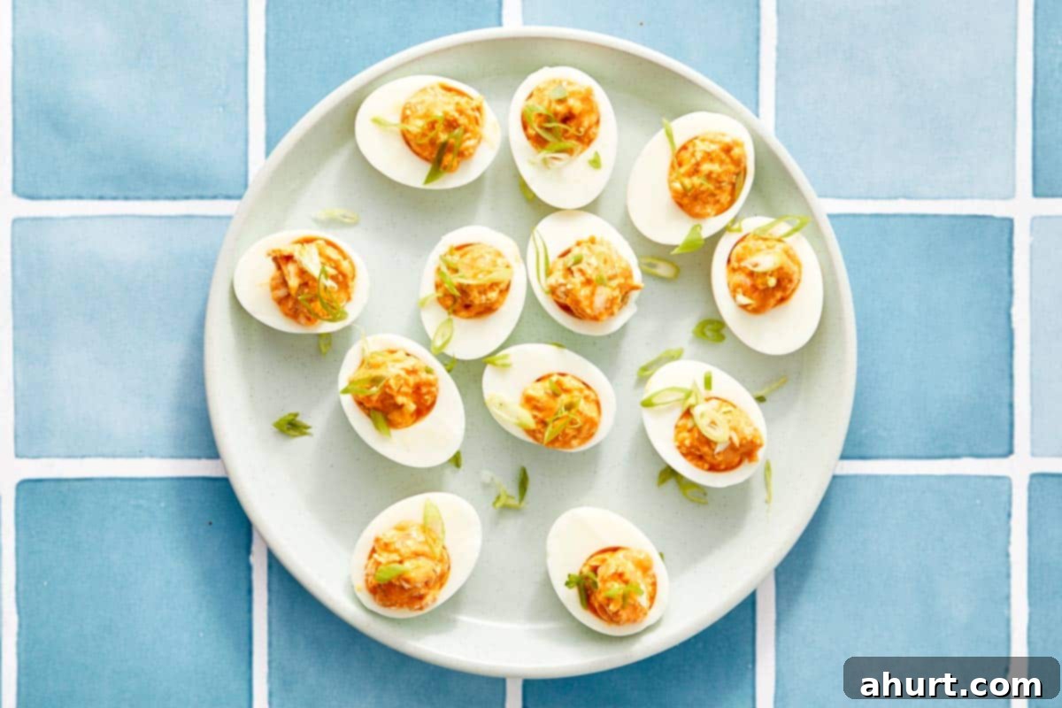 Spicy Buffalo Chicken Deviled Eggs 7 Overhead of buffalo chicken deviled eggs with green onion.