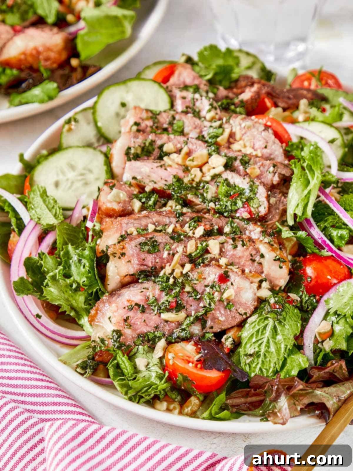 Vibrant Thai Beef Salad 14 Close-up of a beautifully plated Thai Beef Salad, showcasing thinly sliced seared steak and vibrant fresh ingredients.