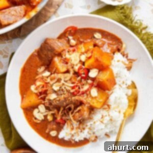 Rich Massaman Beef Curry 11 Massaman Beef Curry served over jasmine rice, topped with peanuts and crispy shallots.