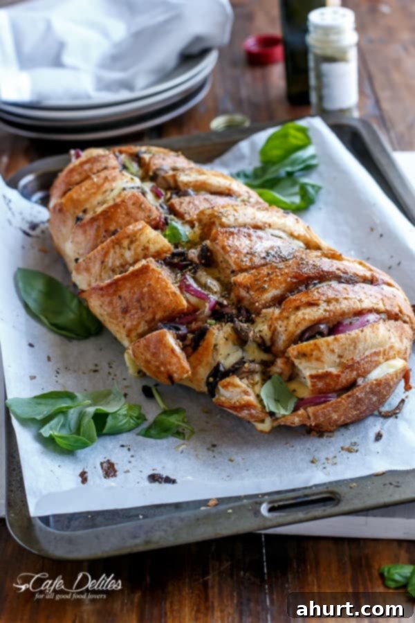 Loaded BBQ Chicken Pizza Pull-Apart Bread 11 A close-up of a bite being pulled from the Barbecue Chicken Pizza Stuffed Bread, with all ingredients visible.
