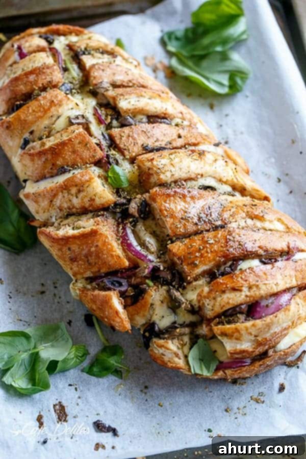 Loaded BBQ Chicken Pizza Pull-Apart Bread 7 Close-up top view of Barbecue Chicken Pizza Stuffed Bread, showing melted cheese and toppings.