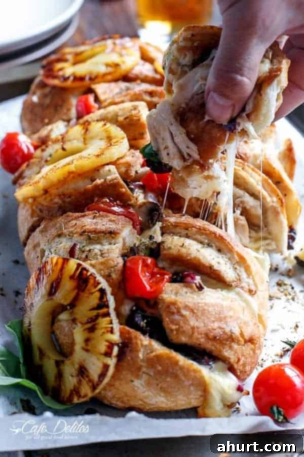 Loaded BBQ Chicken Pizza Pull-Apart Bread 8 Barbecue Chicken Pizza Stuffed Pull Apart Bread, freshly baked on a tray.